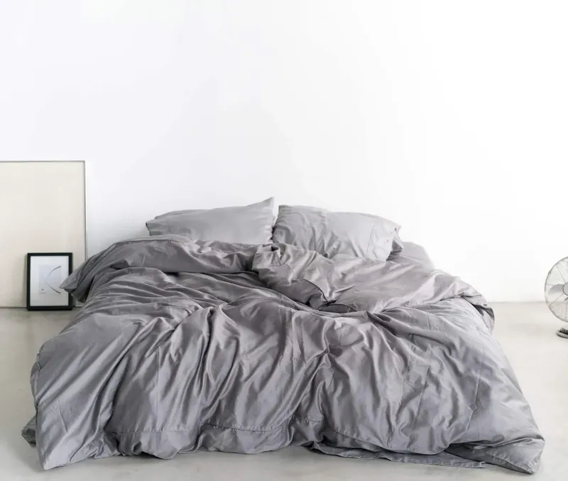 Bed made with gray Miracle Sheets bedding
